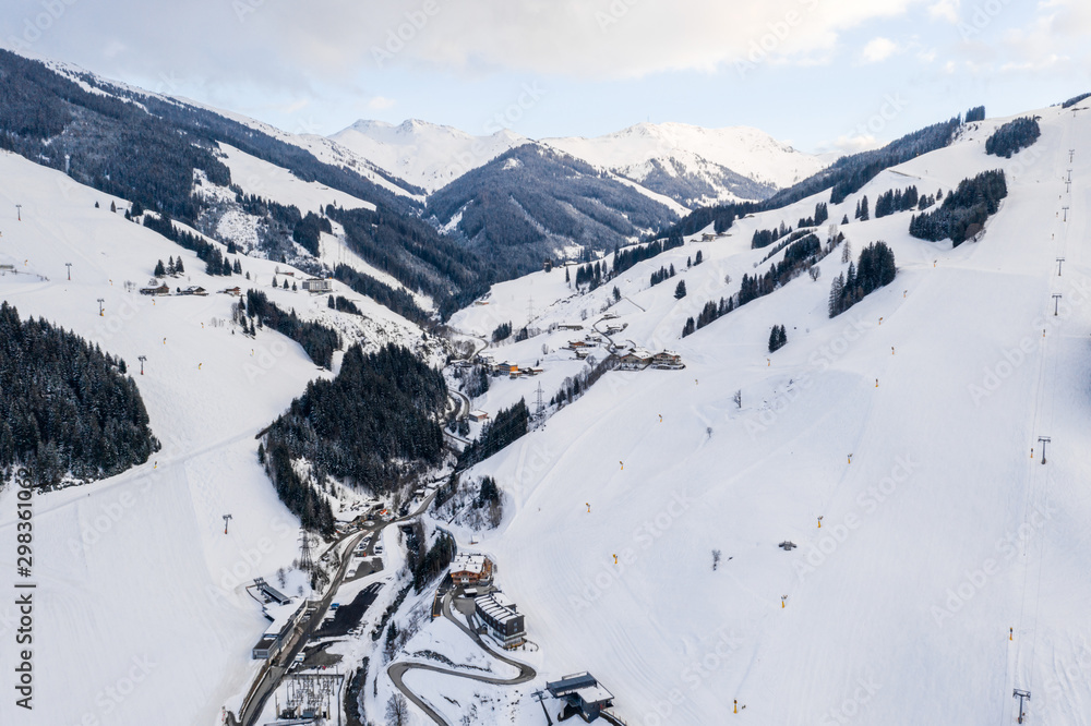 Mountains ski resort Solden Austria - nature and ski slopes by the beautiful winter town. Trees cove