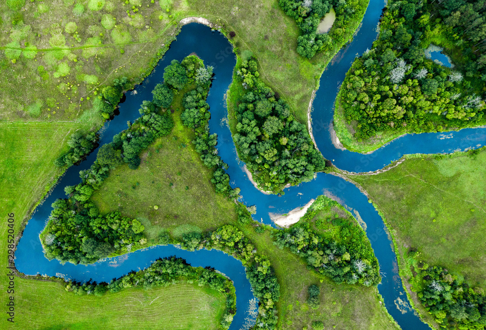 View from above of forest, field and river. Drone shot.