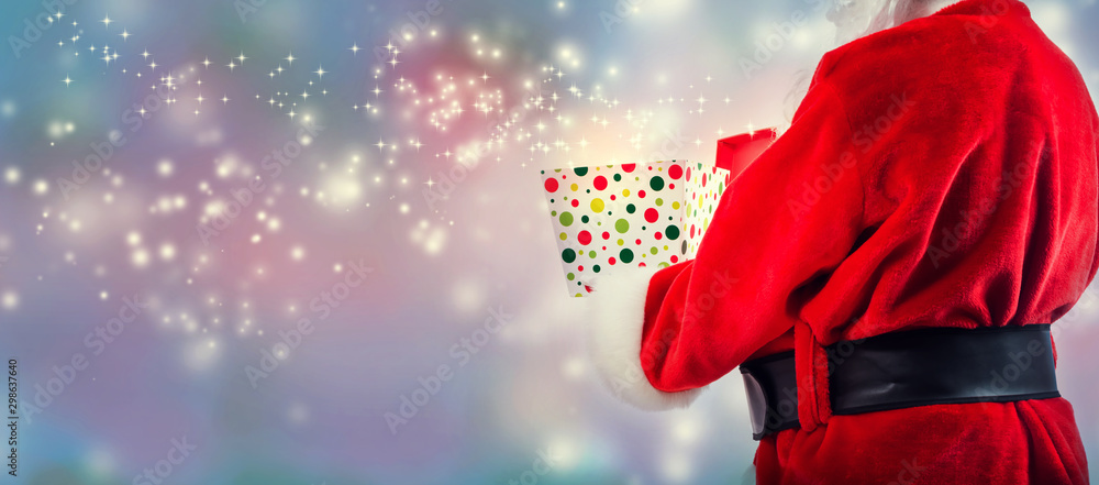 Santa opening a gift box on a shiny light background