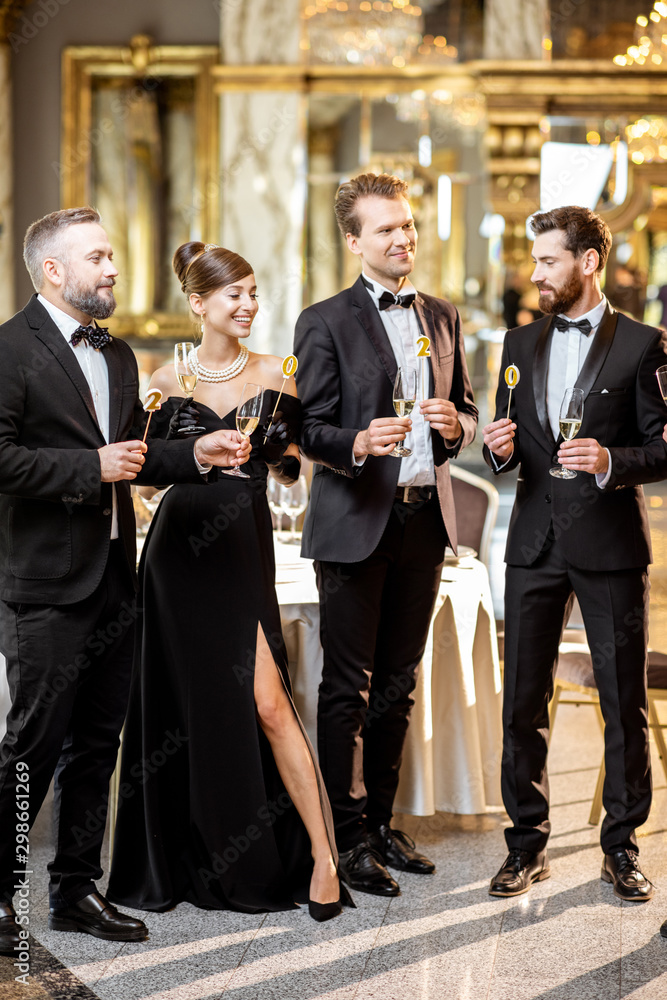 Well-dressed people celebrating New Year indoors