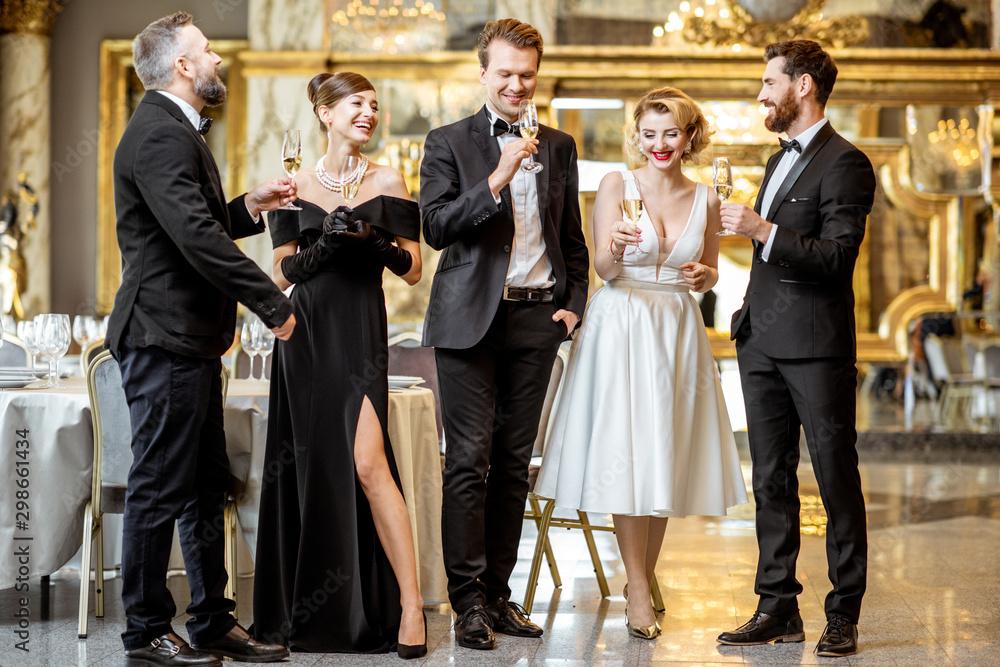 Well-dressed people celebrating New Year indoors