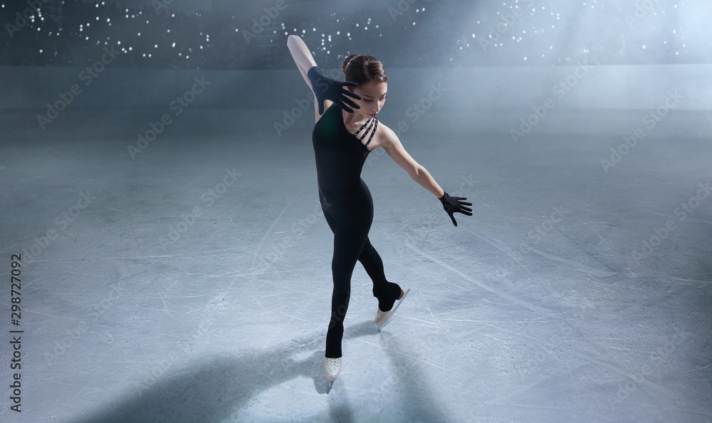 Figure skating girl in ice arena.