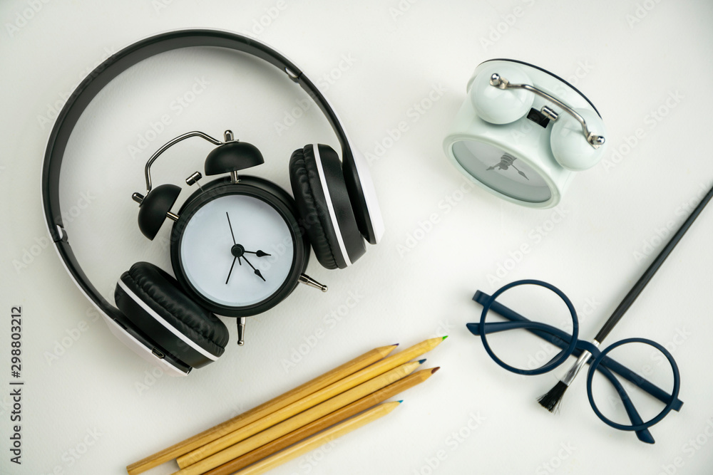 Teacher day concept Background of Glasses teacher,alarm clock,headphone and paint brush on white pap