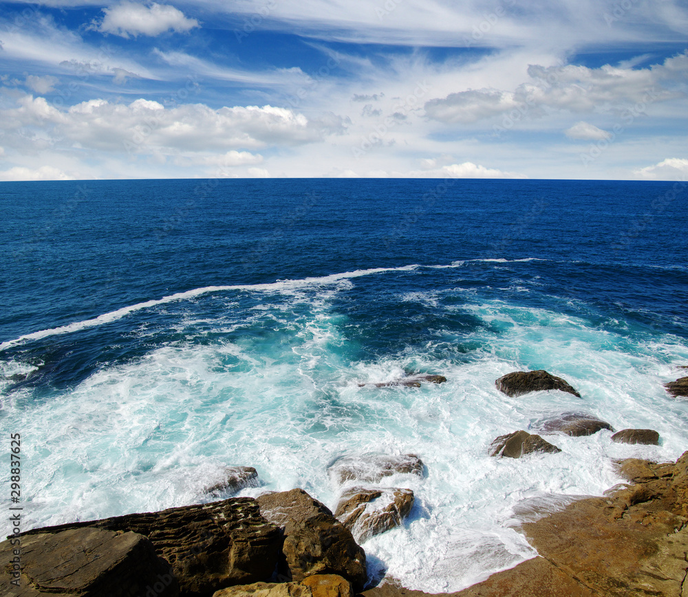 ocean wave crashing on rock