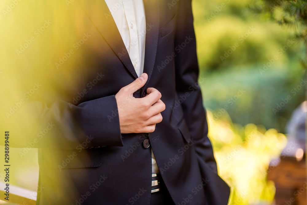 Businessman wears a jacket,male hands closeup,groom getting ready in the morning before wedding cere