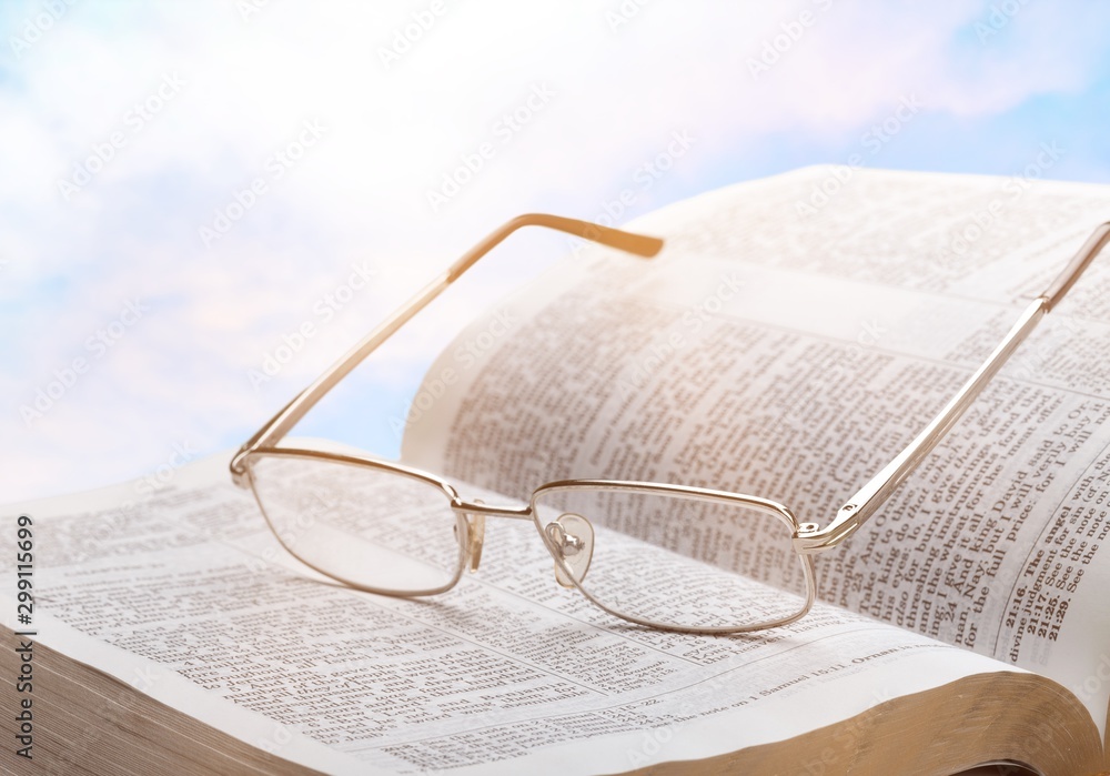 Open book on old wooden table.