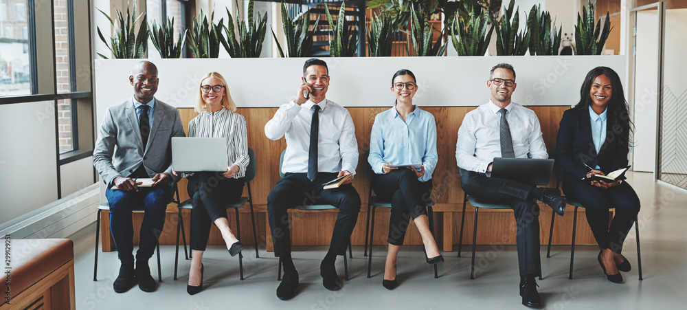 Smiling businesspeople sitting together in an office reception