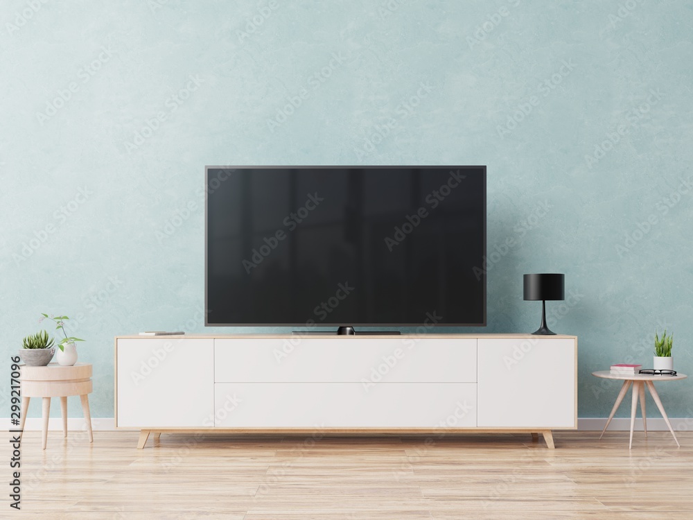 TV on the cabinet in modern living room on blue wall background.