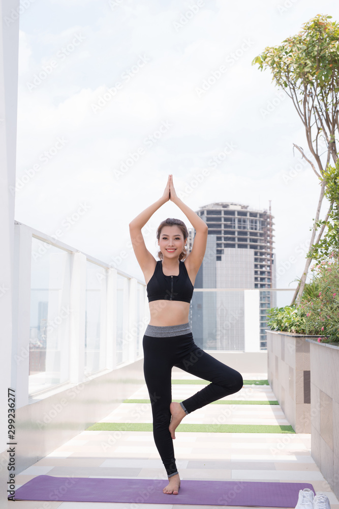 beautiful young woman practicing yoga outdoor