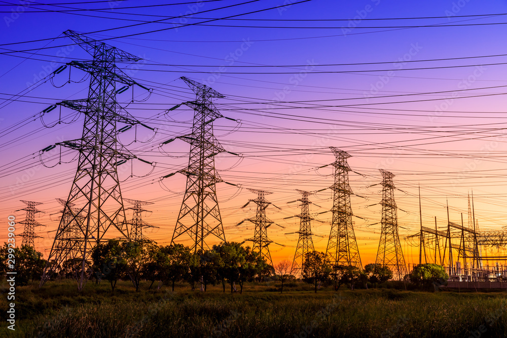 High voltage electricity tower at sunset.substation industrial background.