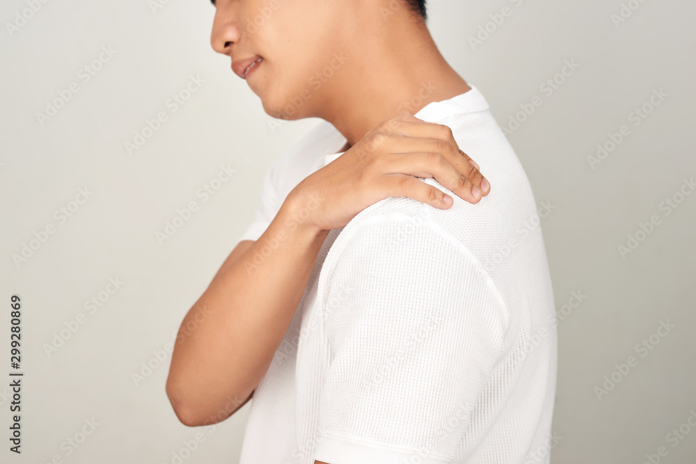 Portrait of handsome Asian man with uncomfortable face, suffering from neck pain. Medical and health