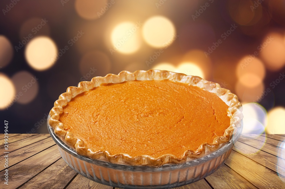 Home made pumpkin pie on white background.