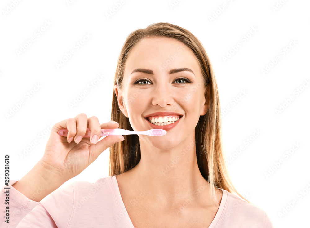 Portrait of woman brushing teeth on white background