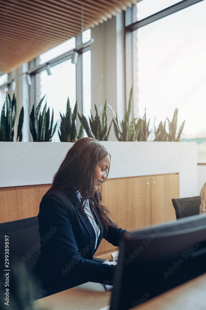 Smiling African American businesswoman busy working in an office