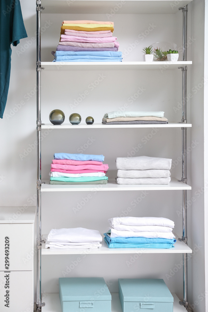 Stacked clean clothes on shelves in show room