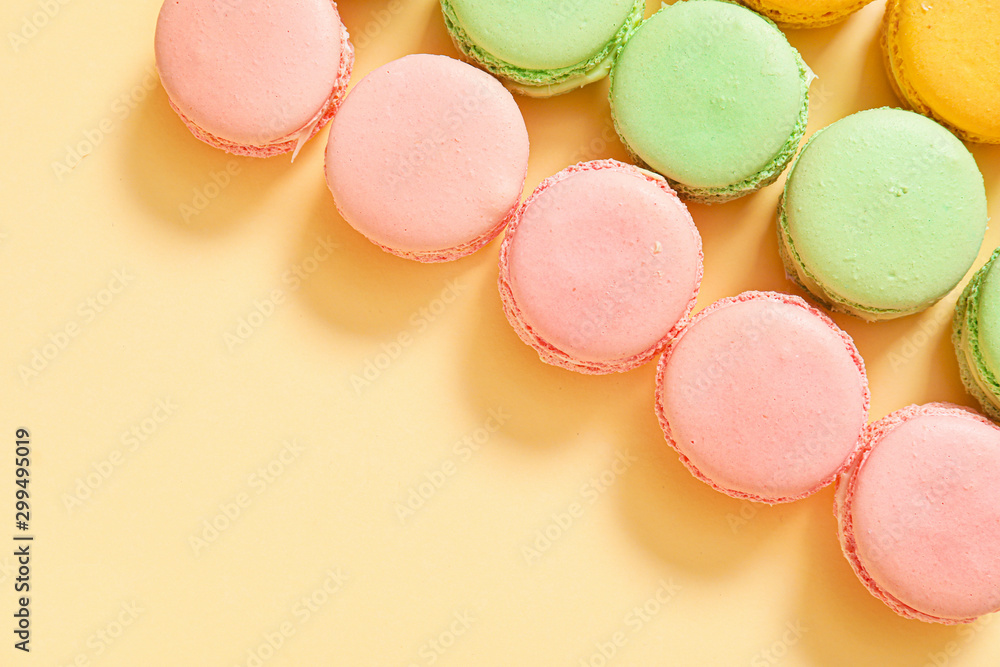 Tasty macarons on color background