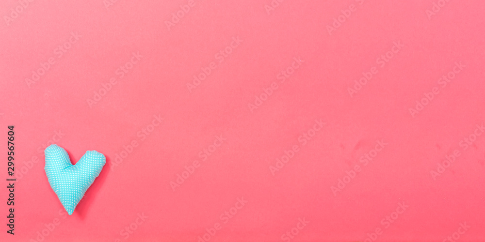 Valentines day heart shaped pillow on a pink paper background