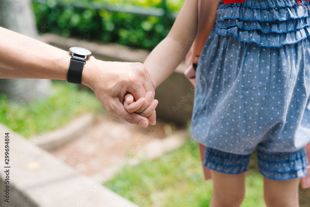 Close up of father holding his daughter hand, so sweet, family time.