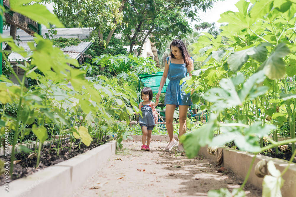 Happy Asian daughter gardening with her mother