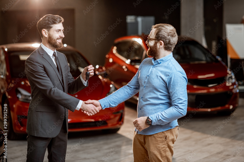 Client with a salesman at the showroom with electric cars