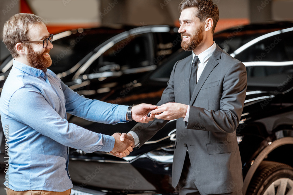 Client with a salesman at the showroom with electric cars