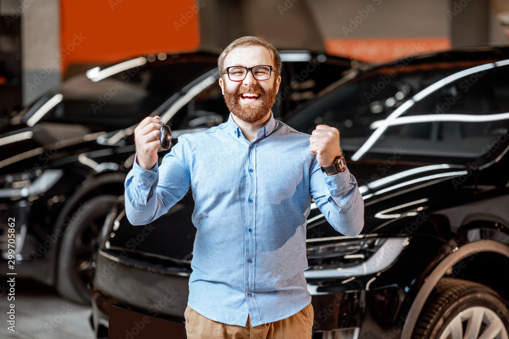 Portrait of a man near electric car at the showroom