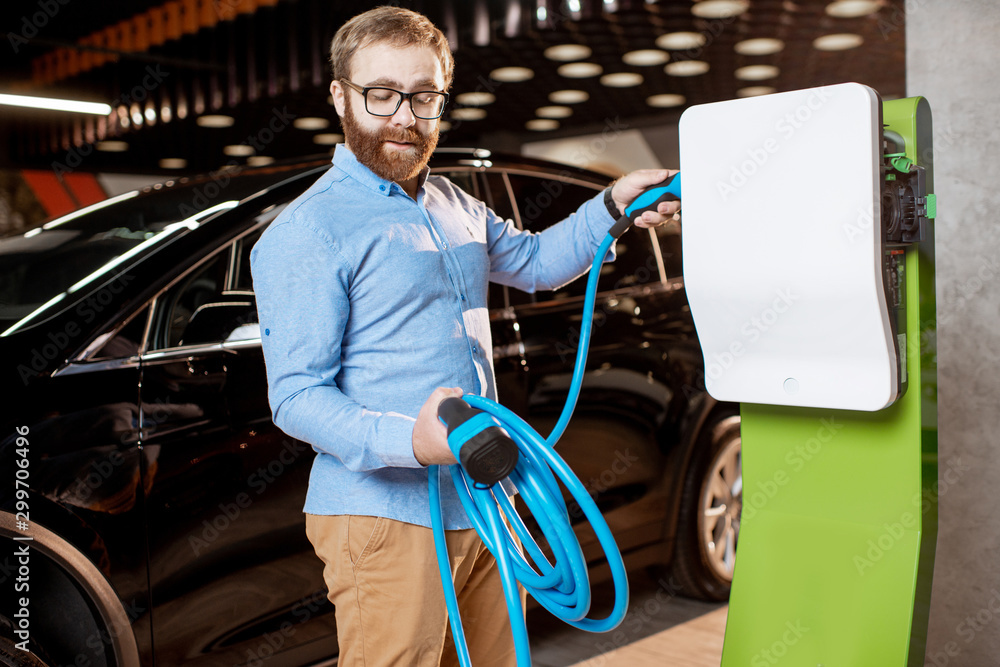 Man choosing car charger at the car dealership