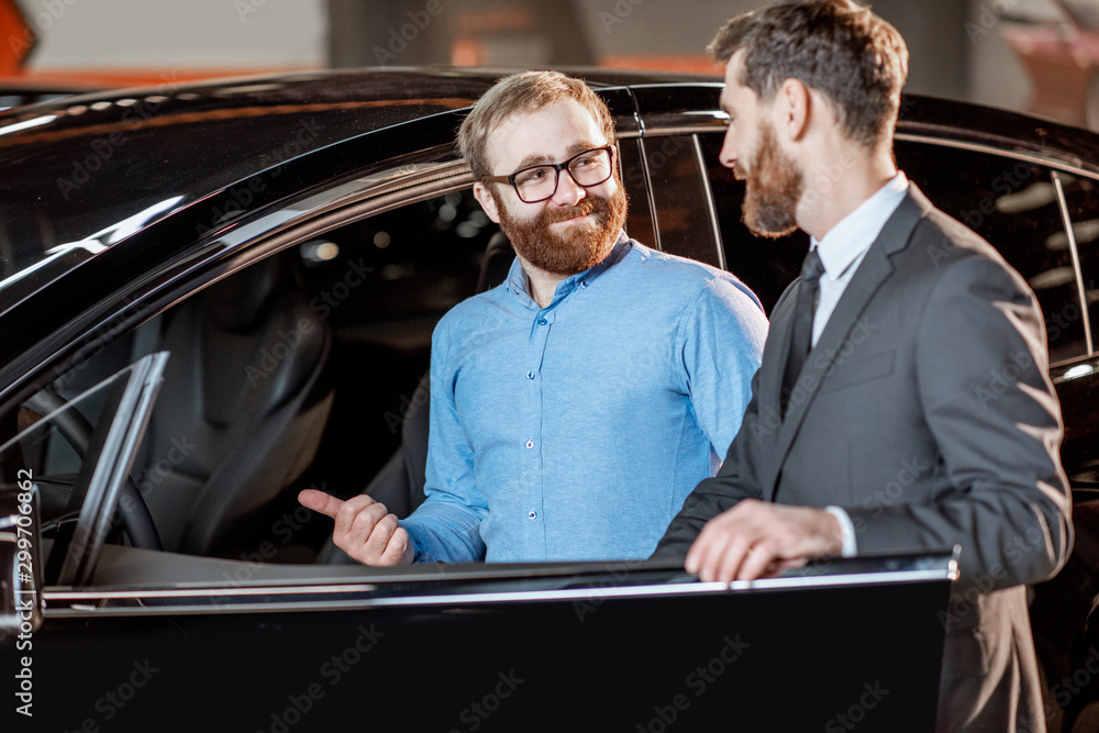 Client with a salesman at the showroom with electric cars