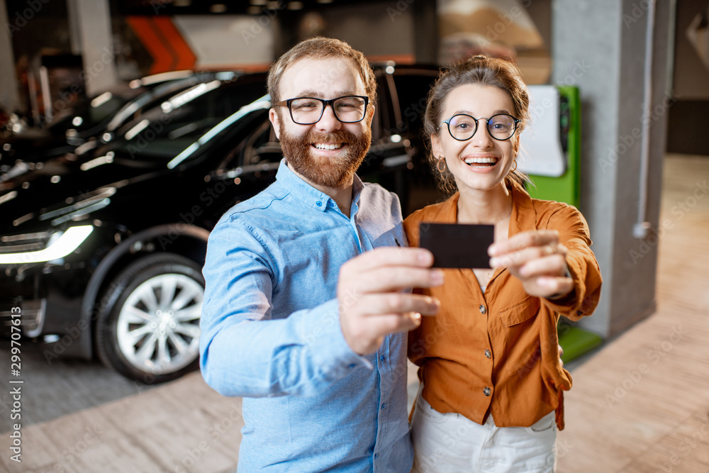 Couple buying electric car at the dealership