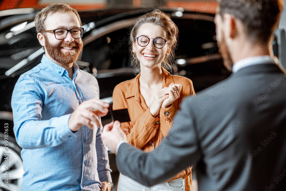 Couple with a seller at the car dealership