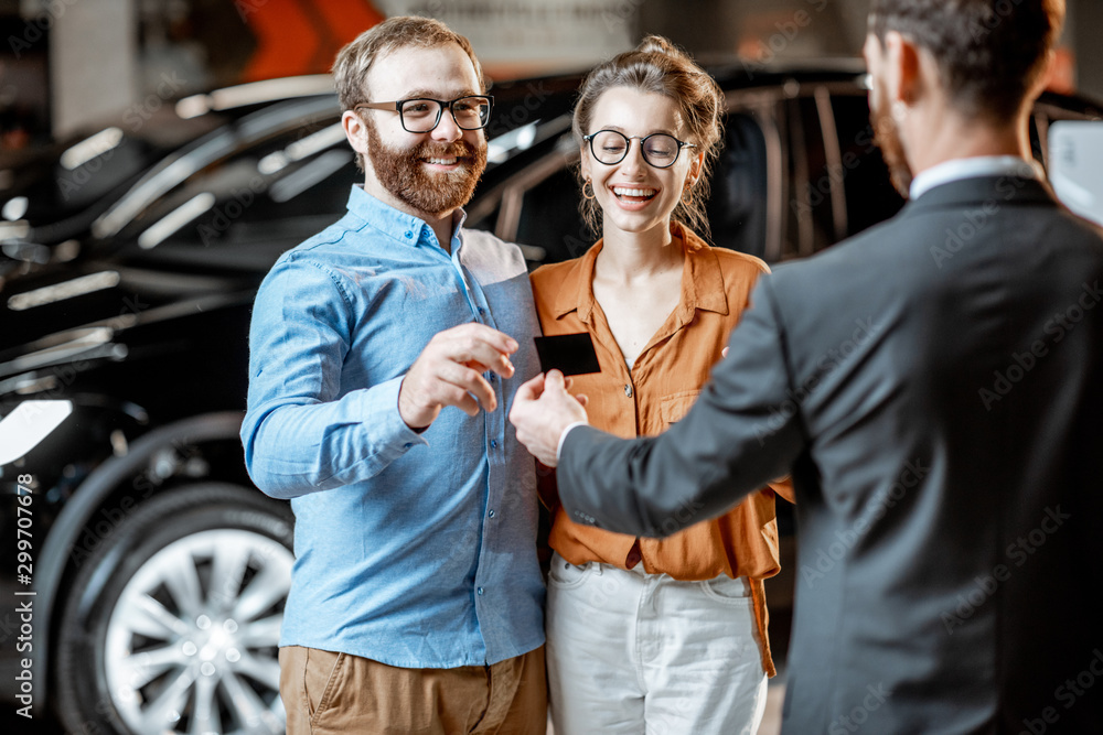 Couple with a seller at the car dealership