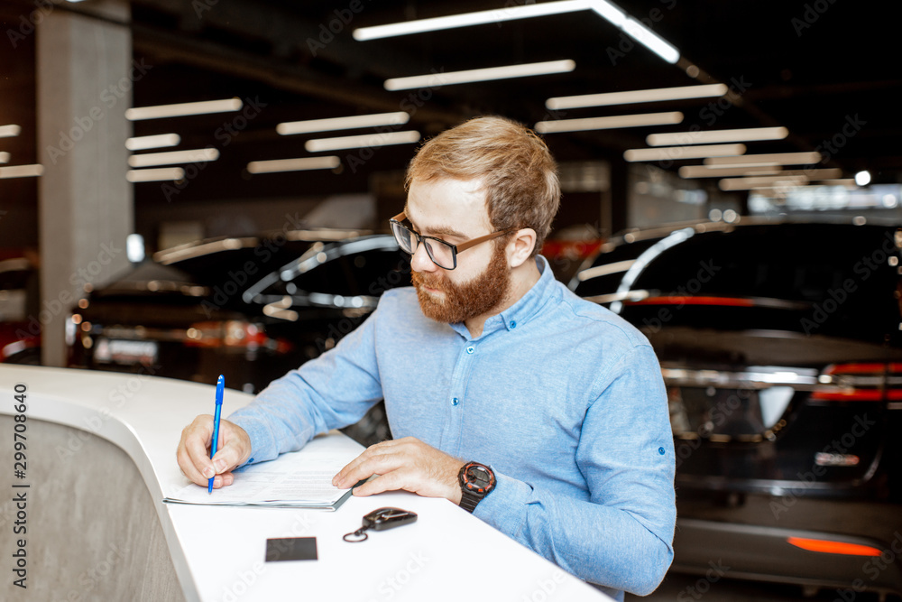 Man buying a new car at the dealership