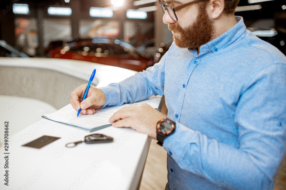 Man buying a new car at the dealership