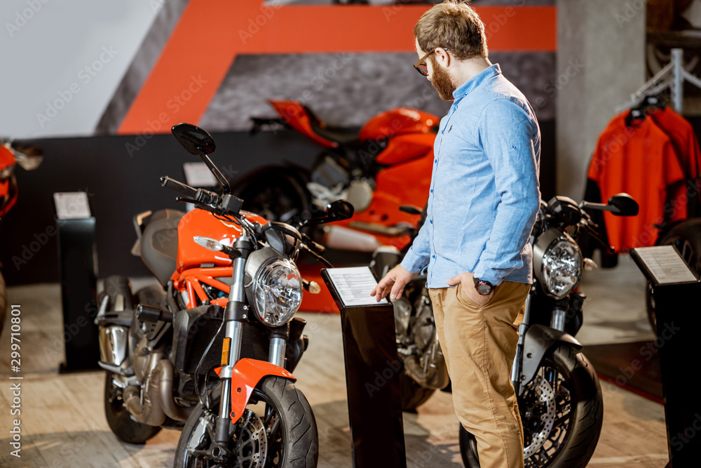 Man choosing a motorcycle in the showroom