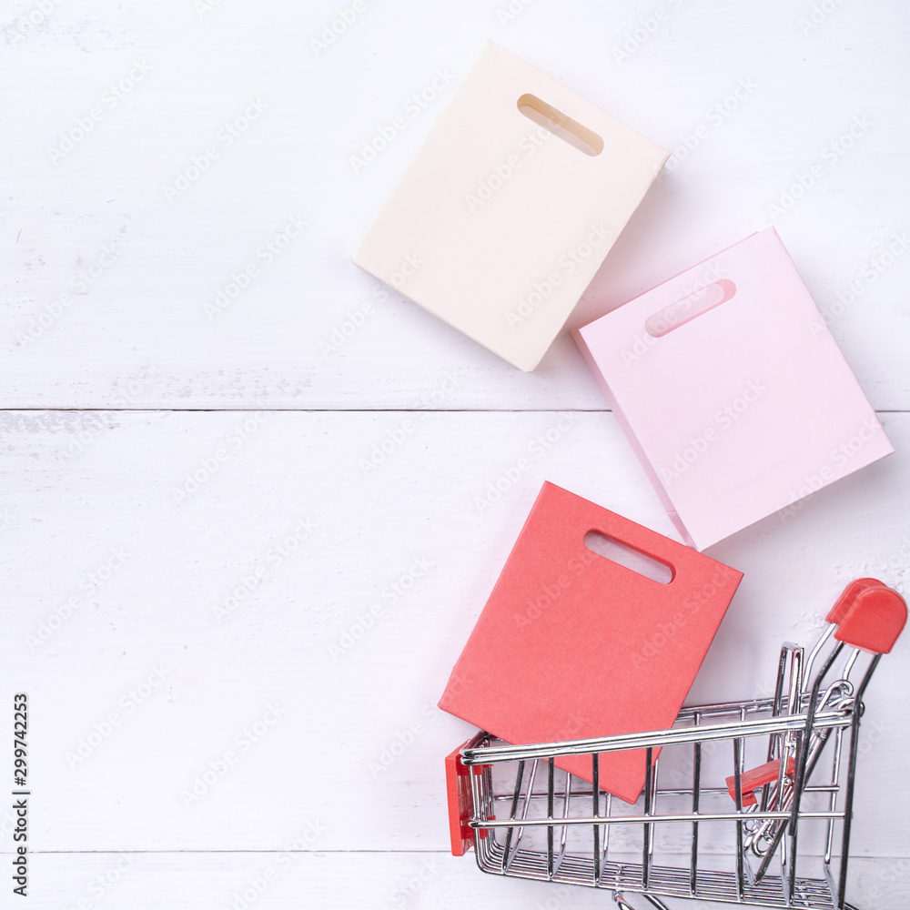 Abstract design element,annual sale,shopping season concept,mini cart with colorful paper bag on whi