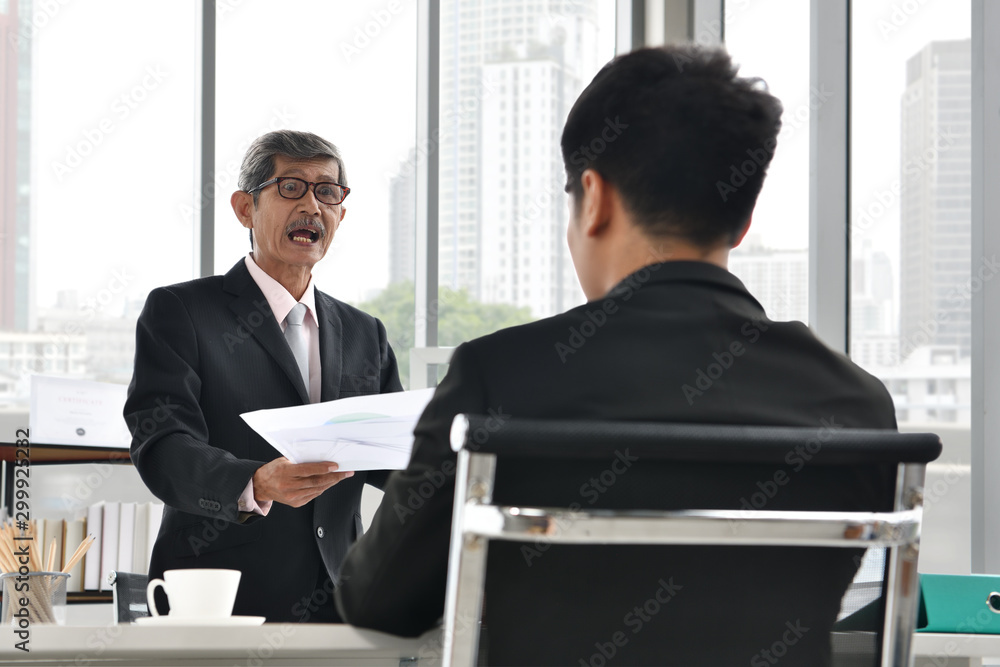 Asian angry boss yelling at employee, business concept