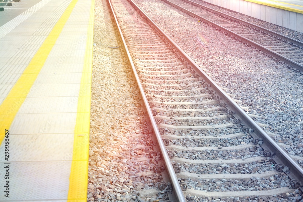  38/5000 Railroad tracks and platform in the light of the sun