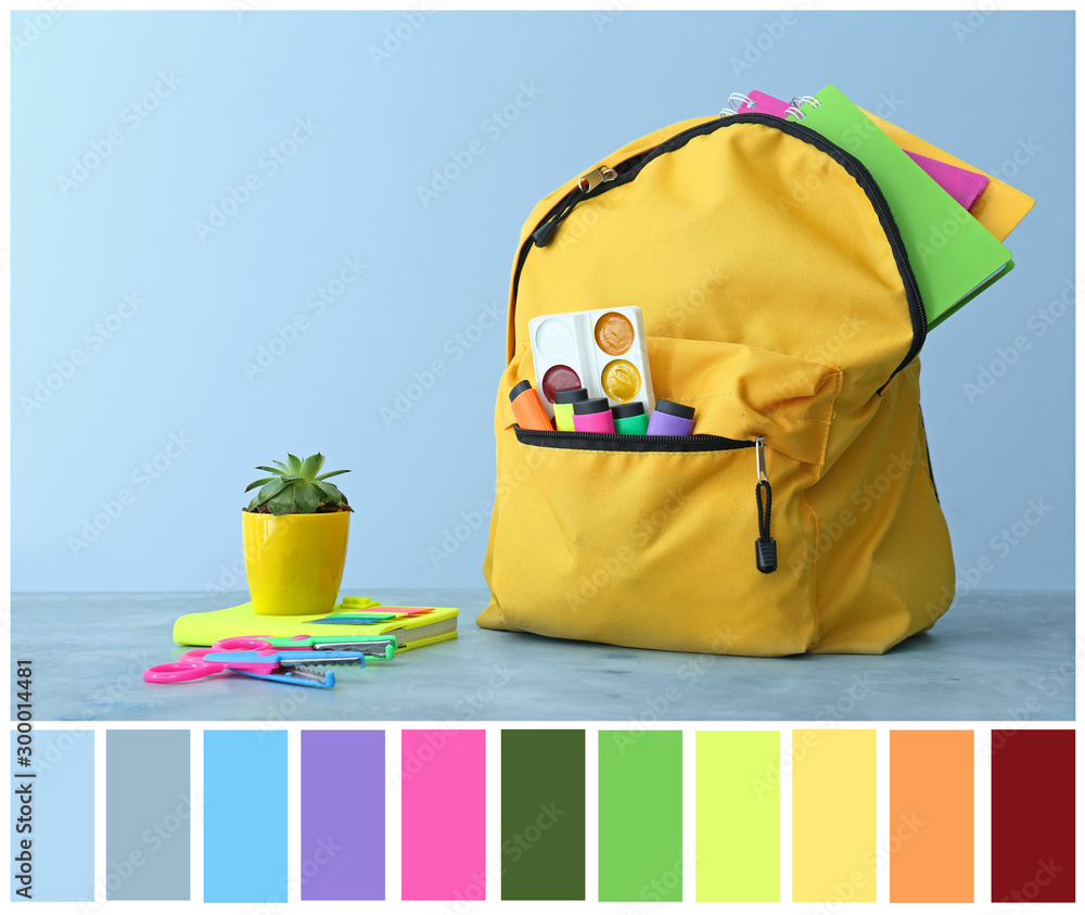 School backpack and stationery on table against color background. Different color patterns