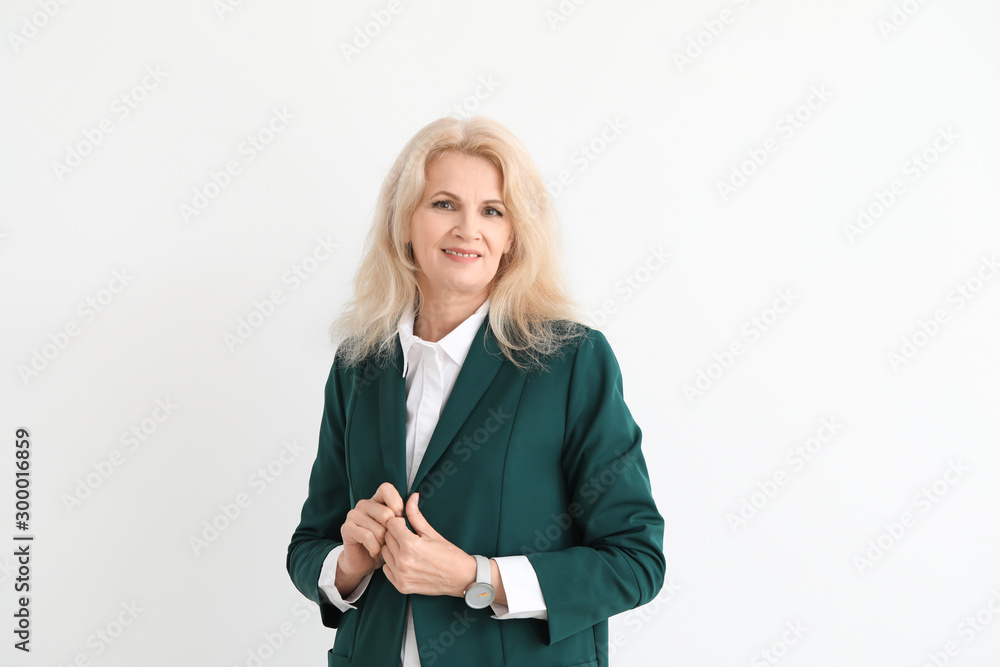 Stylish mature businesswoman on white background