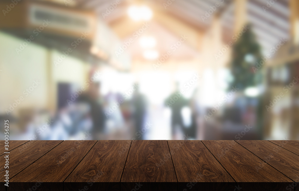 Wood table in blurry background of modern restaurant room or coffee shop with empty copy space on th