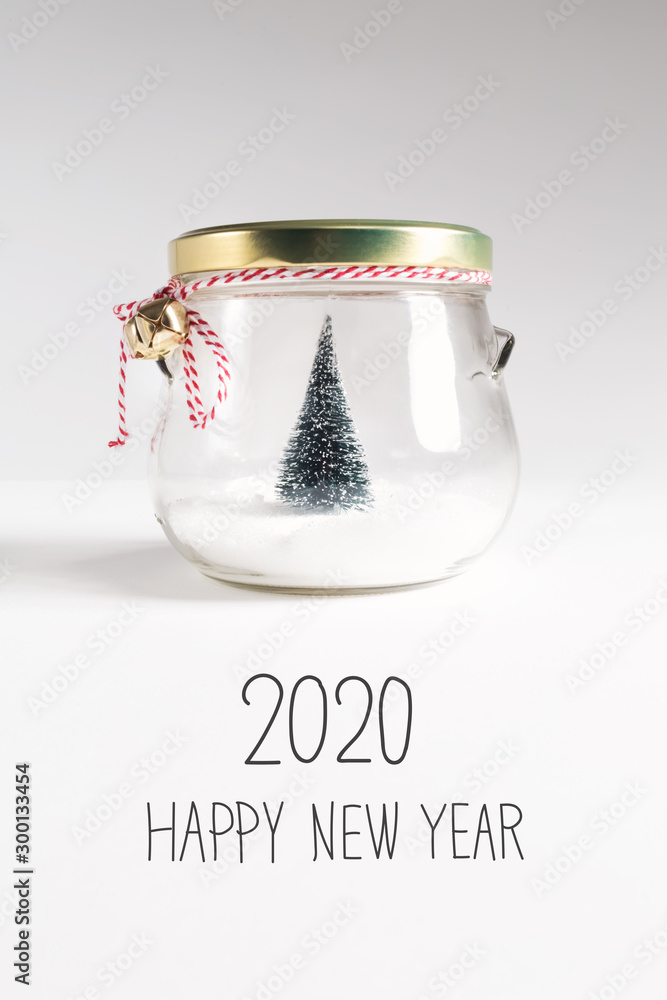 2020 Happy New Year message with Christmas tree in a glass Jar