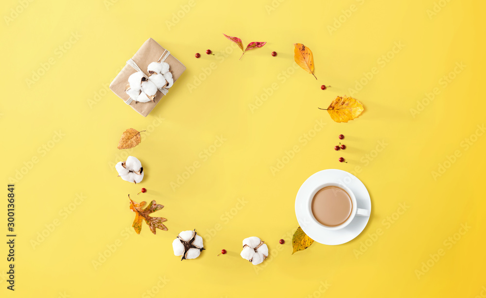 Autumn theme with a cup of coffee and a gift box - overhead view