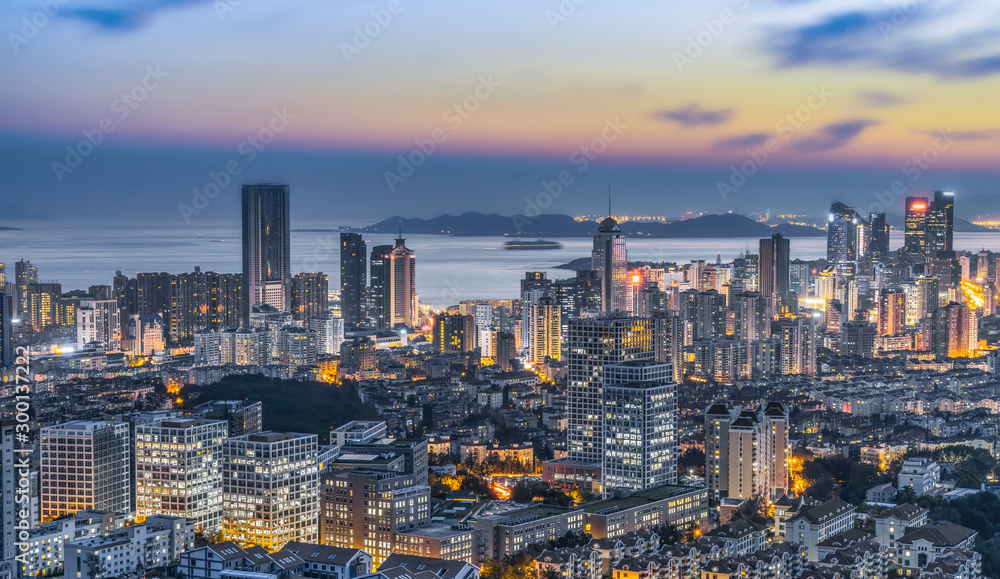 Night view of Qingdao coastline architecture and urban skyline..