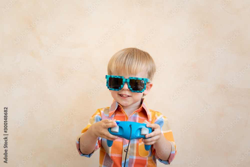 Gamer child playing video game with joystick