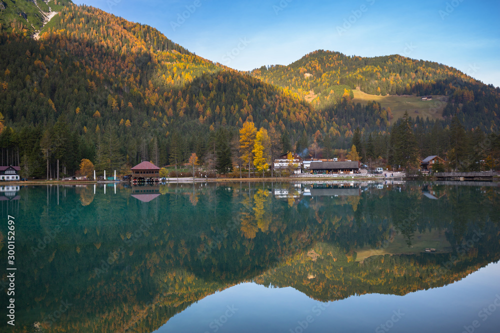 Dolomites mountains with reflection in Lago di Dobbiaca lake at autumn. Italy