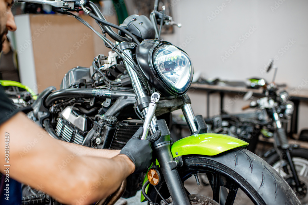 Repairing motorcycle at the workshop