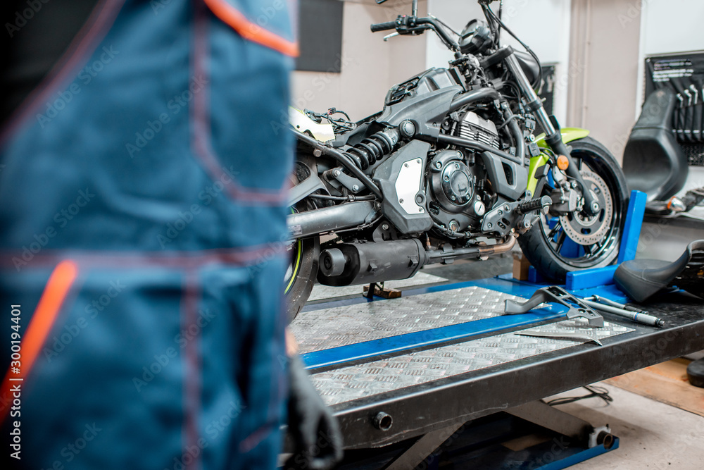 Mechanic and motorcycle at the workshop