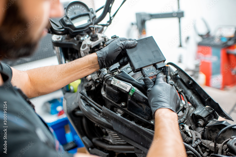 Electrician repairing motorcycle wiring