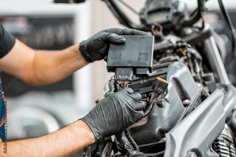 Electrician repairing motorcycle wiring