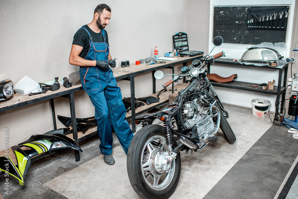 Biker with motorcycles in the garage